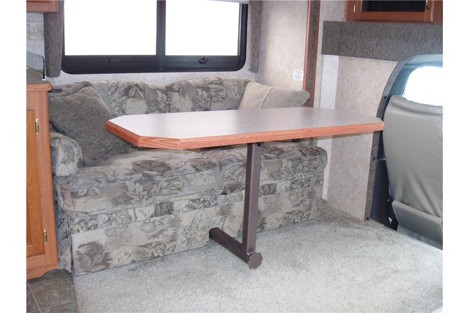 Space-saving couch with retractable dining table